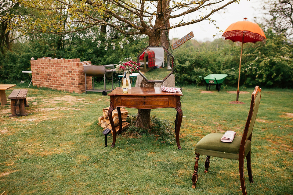 The bride wears a Sabina Motasem gown for her rustic, festival style wedding with glamping near the forrest. Photography by Joanna Nicole.