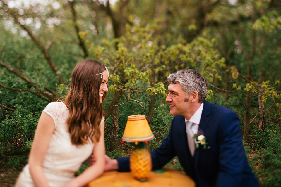 The bride wears a Sabina Motasem gown for her rustic, festival style wedding with glamping near the forrest. Photography by Joanna Nicole.