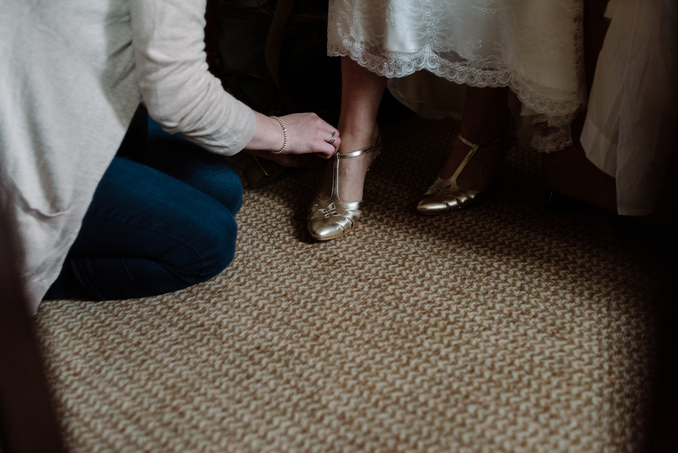 The bride wears a drop waist 1920s style wedding dress by Charlie Brear for her Manchester city wedding. Photography by Neil Thomas Douglas