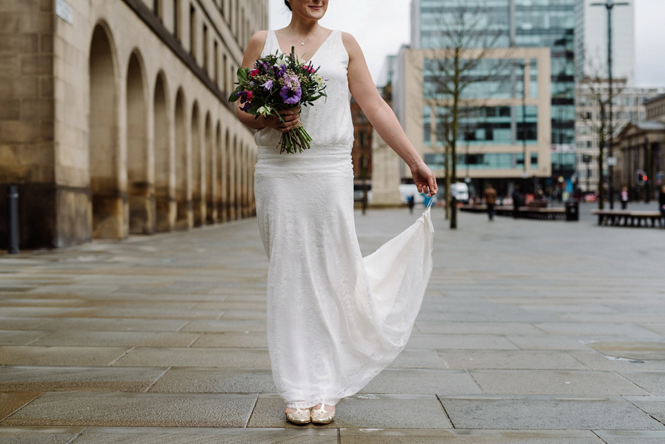 The bride wears a drop waist 1920s style wedding dress by Charlie Brear for her Manchester city wedding. Photography by Neil Thomas Douglas