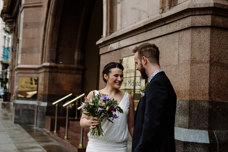 The bride wears a drop waist 1920s style wedding dress by Charlie Brear for her Manchester city wedding. Photography by Neil Thomas Douglas