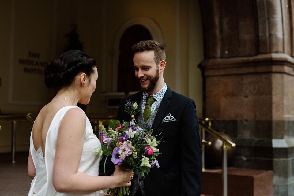 The bride wears a drop waist 1920s style wedding dress by Charlie Brear for her Manchester city wedding. Photography by Neil Thomas Douglas