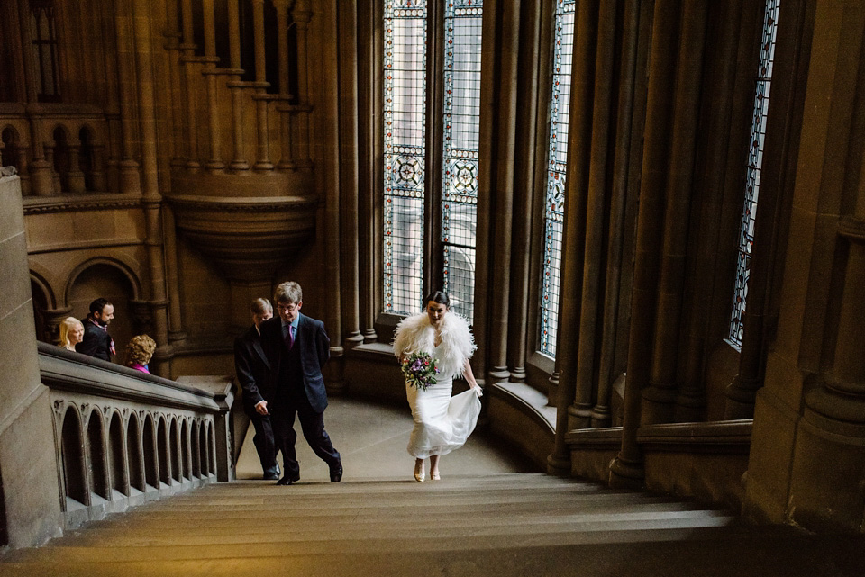 The bride wears a drop waist 1920s style wedding dress by Charlie Brear for her Manchester city wedding. Photography by Neil Thomas Douglas