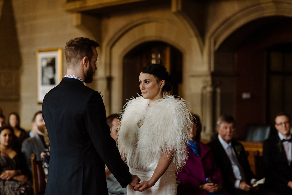 The bride wears a drop waist 1920s style wedding dress by Charlie Brear for her Manchester city wedding. Photography by Neil Thomas Douglas