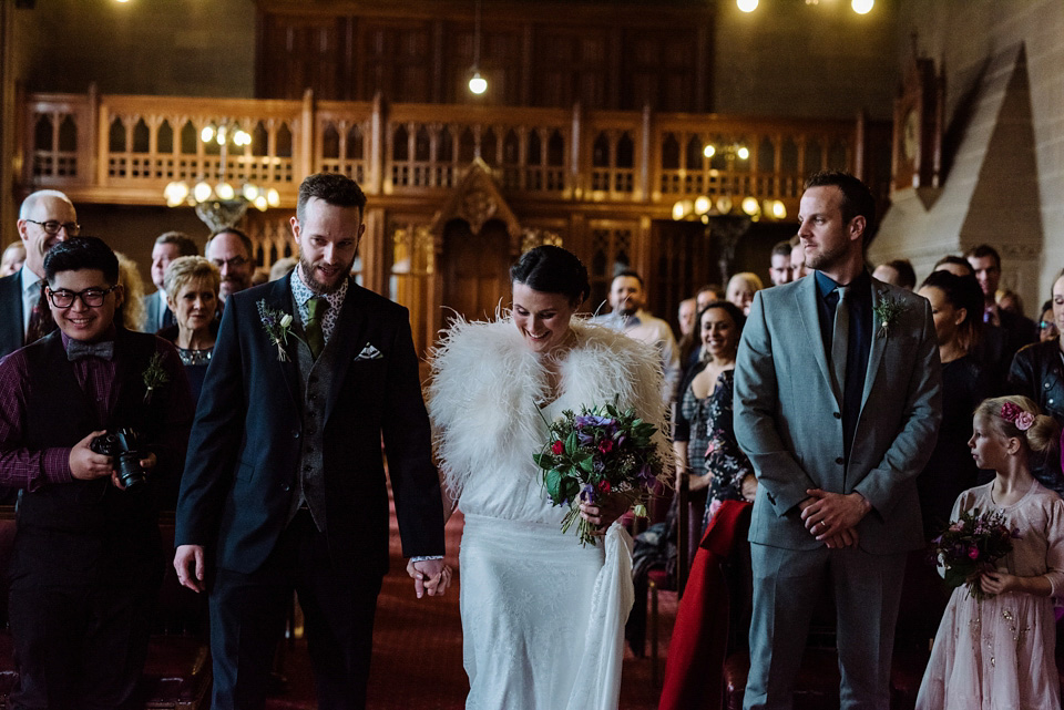 The bride wears a drop waist 1920s style wedding dress by Charlie Brear for her Manchester city wedding. Photography by Neil Thomas Douglas