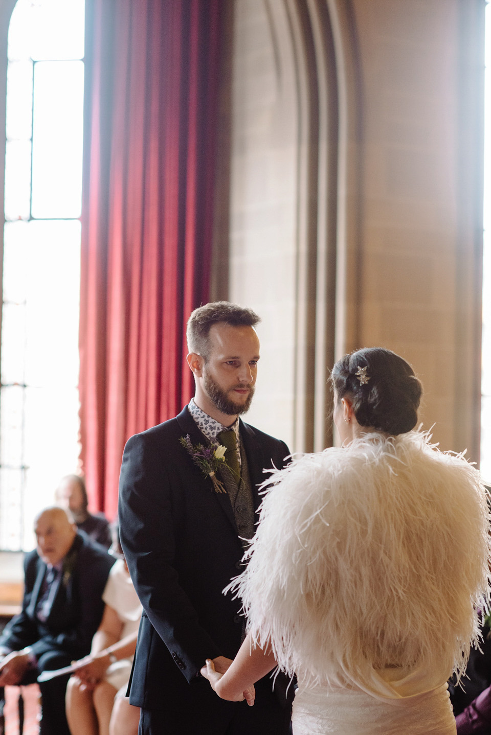 The bride wears a drop waist 1920s style wedding dress by Charlie Brear for her Manchester city wedding. Photography by Neil Thomas Douglas