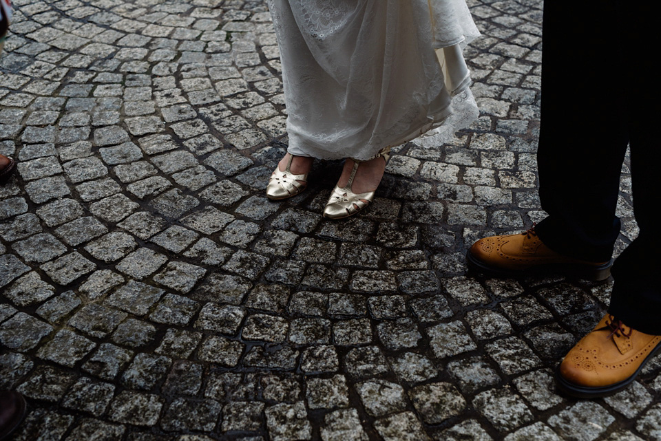 The bride wears a drop waist 1920s style wedding dress by Charlie Brear for her Manchester city wedding. Photography by Neil Thomas Douglas