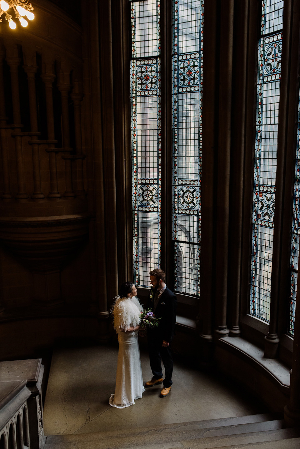 The bride wears a drop waist 1920s style wedding dress by Charlie Brear for her Manchester city wedding. Photography by Neil Thomas Douglas