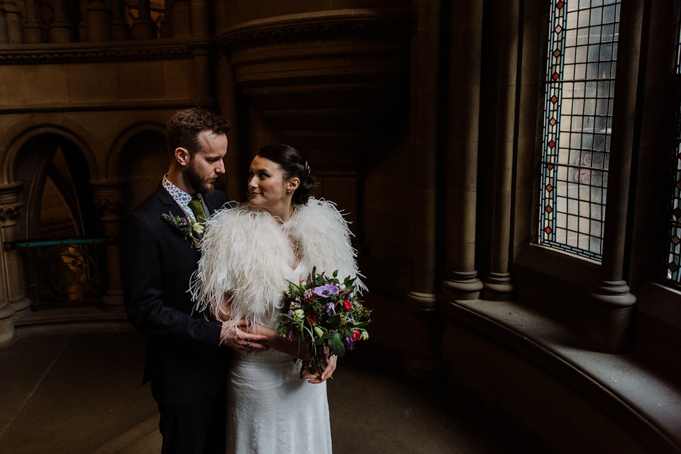 The bride wears a drop waist 1920s style wedding dress by Charlie Brear for her Manchester city wedding. Photography by Neil Thomas Douglas