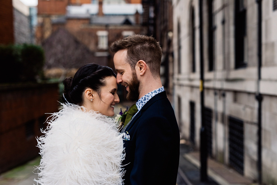 The bride wears a drop waist 1920s style wedding dress by Charlie Brear for her Manchester city wedding. Photography by Neil Thomas Douglas