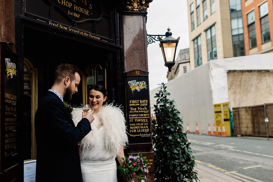 The bride wears a drop waist 1920s style wedding dress by Charlie Brear for her Manchester city wedding. Photography by Neil Thomas Douglas