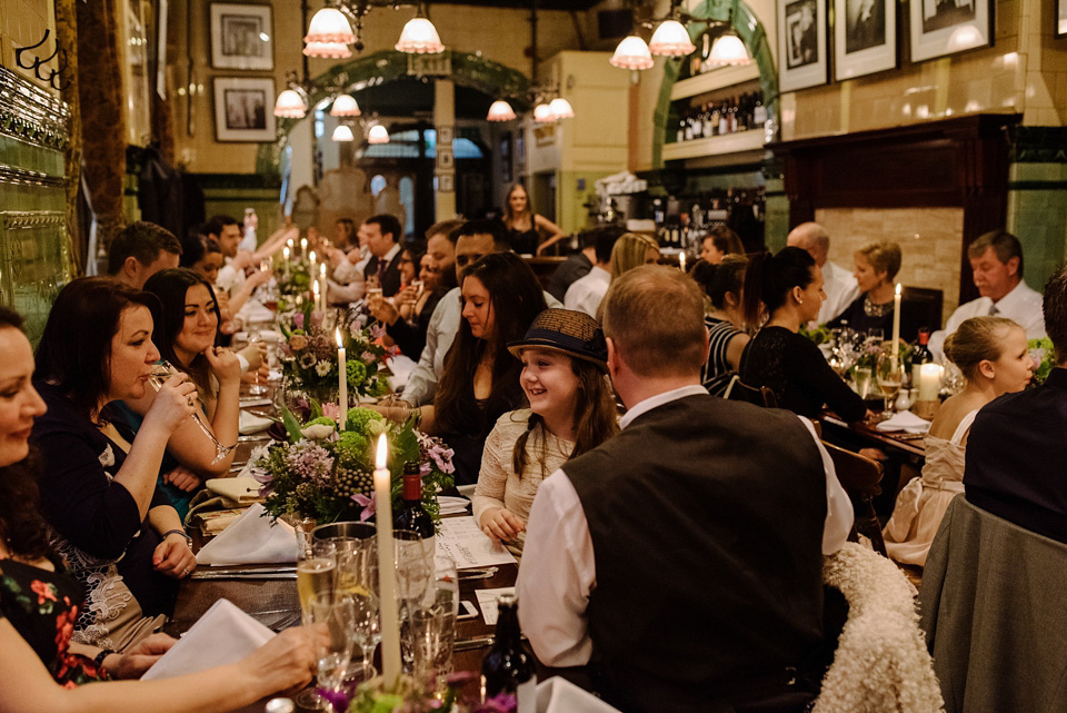 The bride wears a drop waist 1920s style wedding dress by Charlie Brear for her Manchester city wedding. Photography by Neil Thomas Douglas