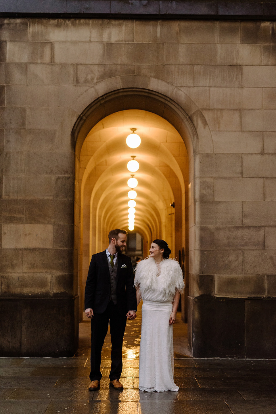 The bride wears a drop waist 1920s style wedding dress by Charlie Brear for her Manchester city wedding. Photography by Neil Thomas Douglas