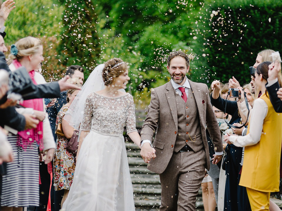 Bride Thea wears a Halfpenny London gown for her laid back dinner party wedding. Photography by John Barwood.