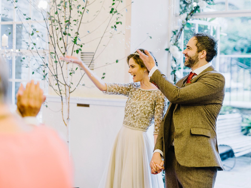 Bride Thea wears a Halfpenny London gown for her laid back dinner party wedding. Photography by John Barwood.