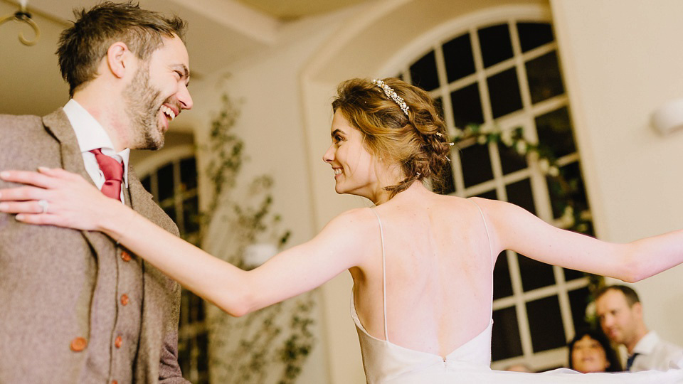 Bride Thea wears a Halfpenny London gown for her laid back dinner party wedding. Photography by John Barwood.