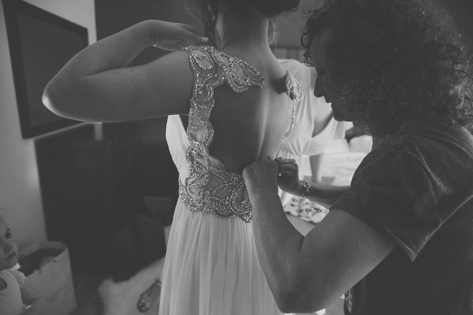 A grecian style gown by Jenny Packham for a rustic inspired Italian Scottish Humanist barn wedding. Images by Mirrorbox Photography.