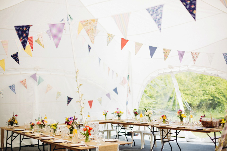 The bride wears a top and skirt for her charming orchard wedding. Photography by Cat Lane.