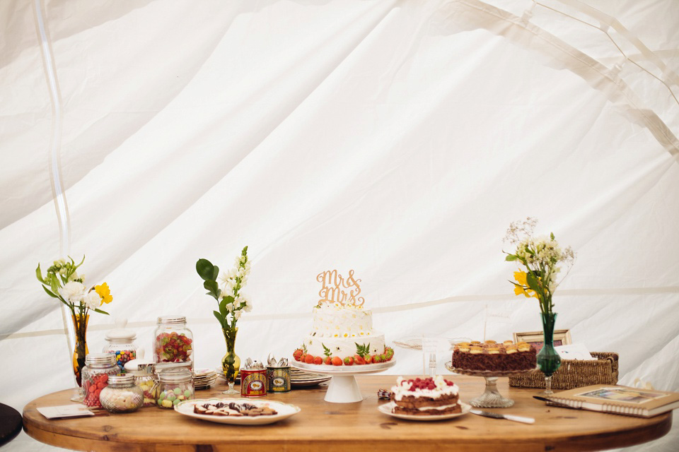 The bride wears a top and skirt for her charming orchard wedding. Photography by Cat Lane.