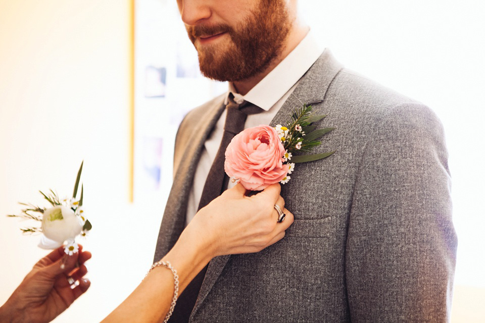 The bride wears a top and skirt for her charming orchard wedding. Photography by Cat Lane.