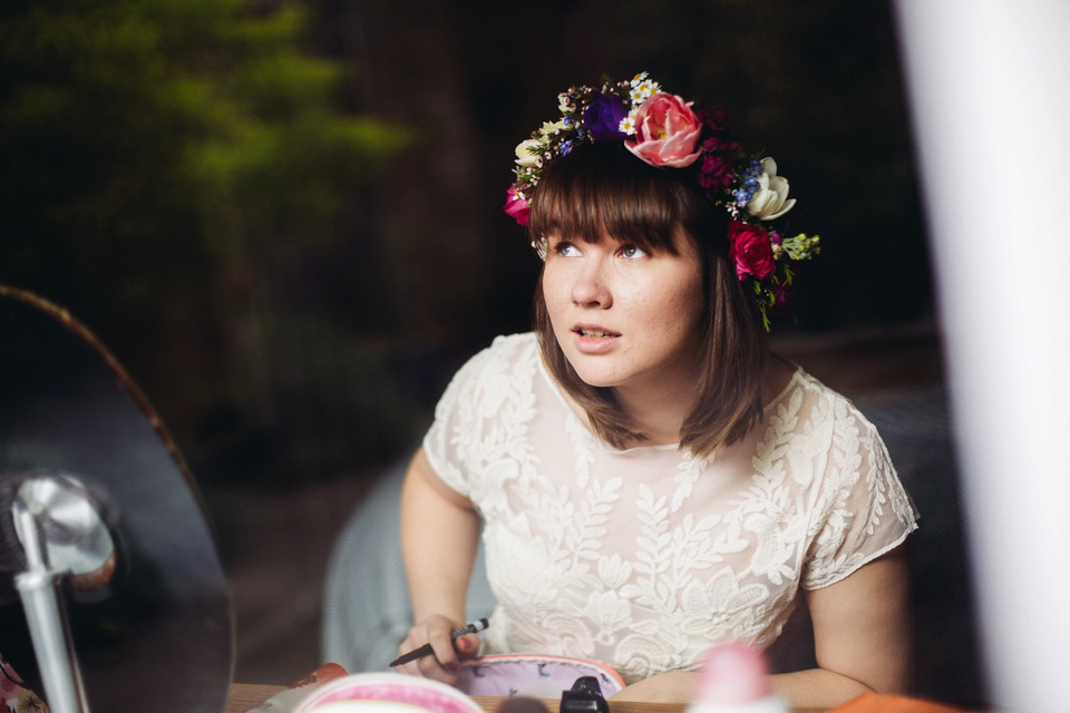 The bride wears a top and skirt for her charming orchard wedding. Photography by Cat Lane.