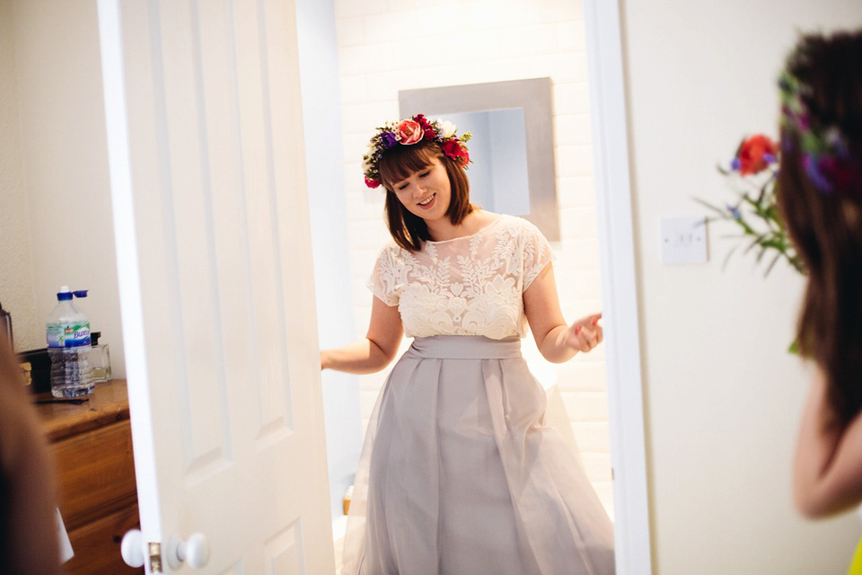 The bride wears a top and skirt for her charming orchard wedding. Photography by Cat Lane.