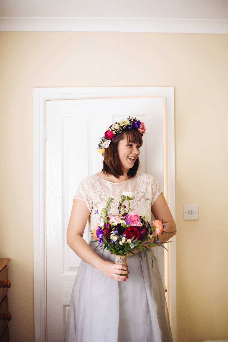 The bride wears a top and skirt for her charming orchard wedding. Photography by Cat Lane.