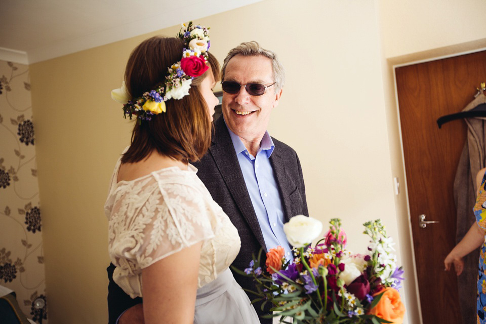 The bride wears a top and skirt for her charming orchard wedding. Photography by Cat Lane.