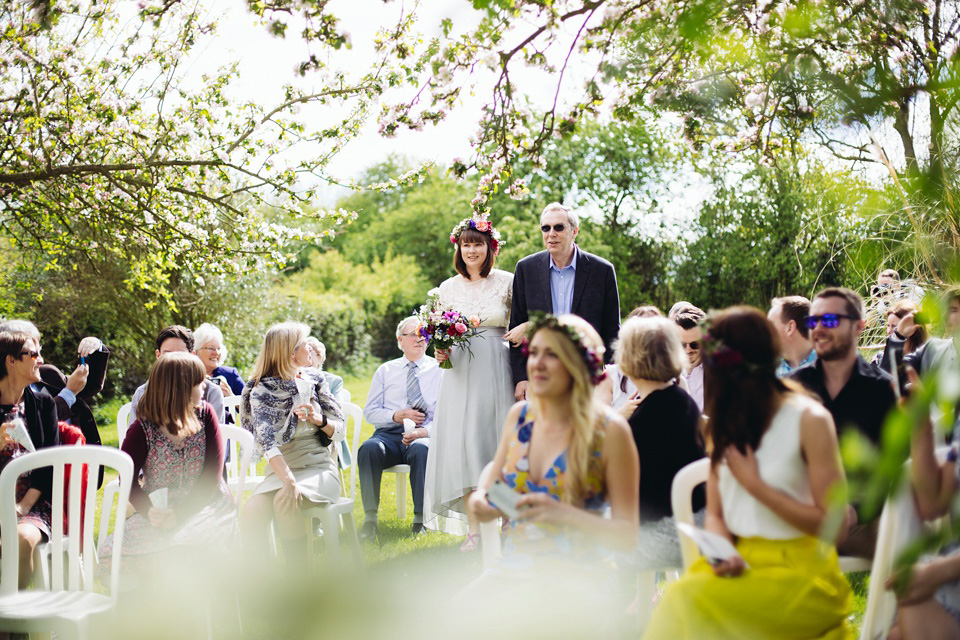 The bride wears a top and skirt for her charming orchard wedding. Photography by Cat Lane.