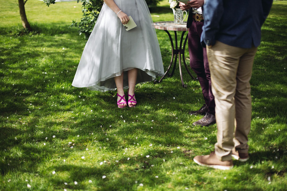 The bride wears a top and skirt for her charming orchard wedding. Photography by Cat Lane.