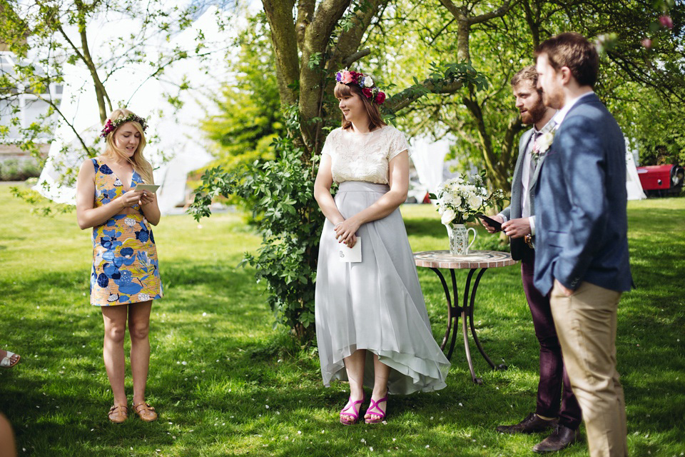 The bride wears a top and skirt for her charming orchard wedding. Photography by Cat Lane.