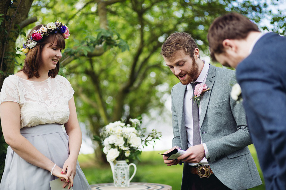 The bride wears a top and skirt for her charming orchard wedding. Photography by Cat Lane.