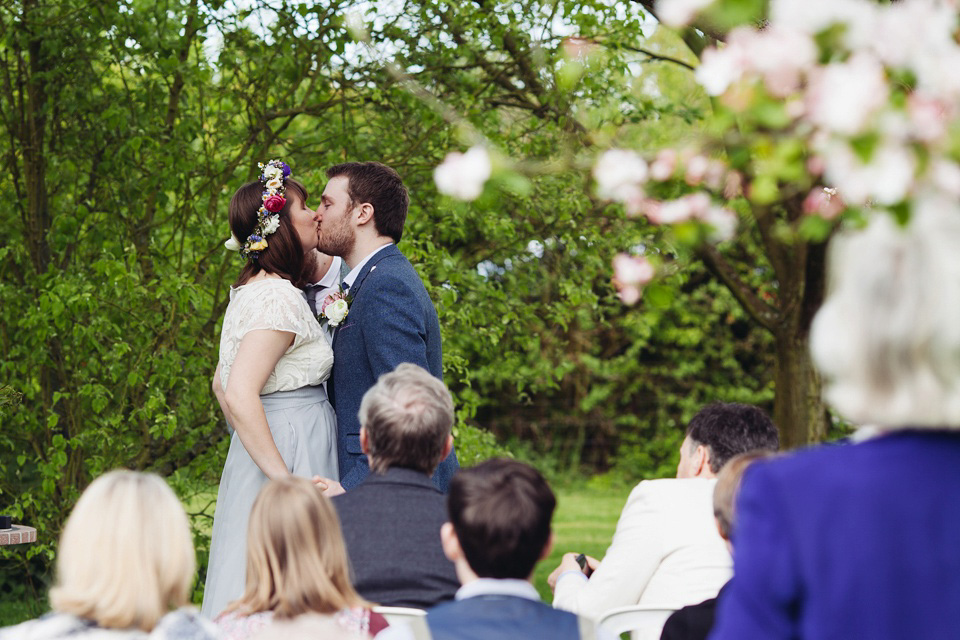 The bride wears a top and skirt for her charming orchard wedding. Photography by Cat Lane.