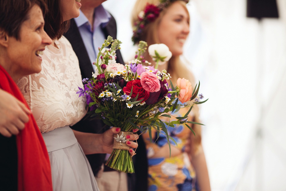 The bride wears a top and skirt for her charming orchard wedding. Photography by Cat Lane.