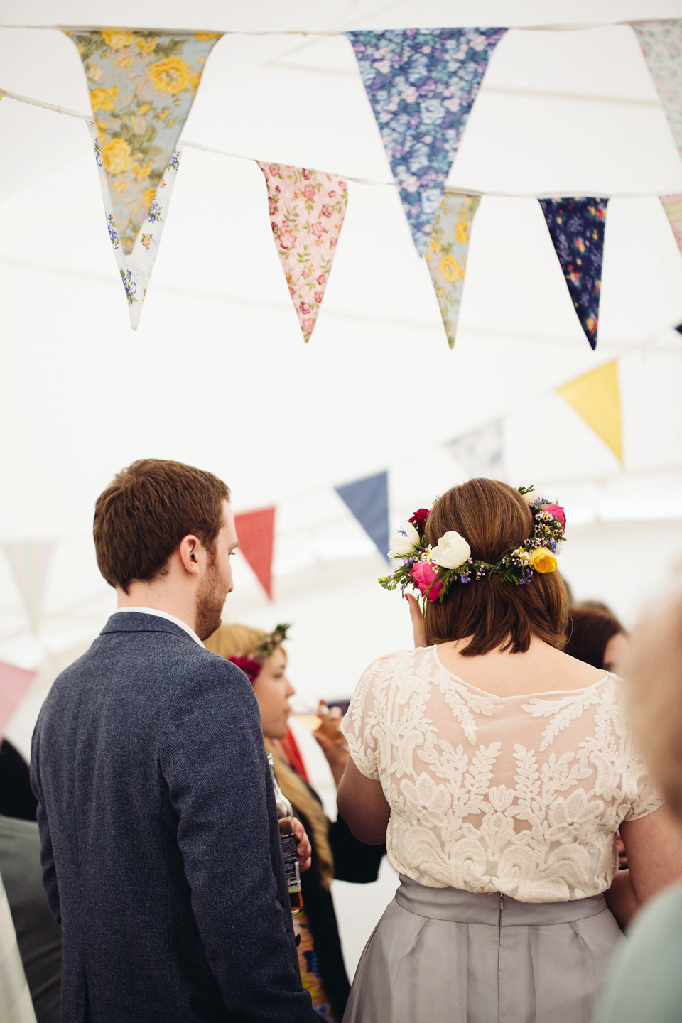 The bride wears a top and skirt for her charming orchard wedding. Photography by Cat Lane.