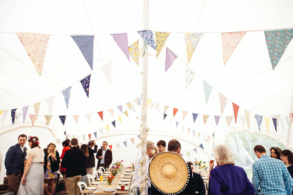 The bride wears a top and skirt for her charming orchard wedding. Photography by Cat Lane.