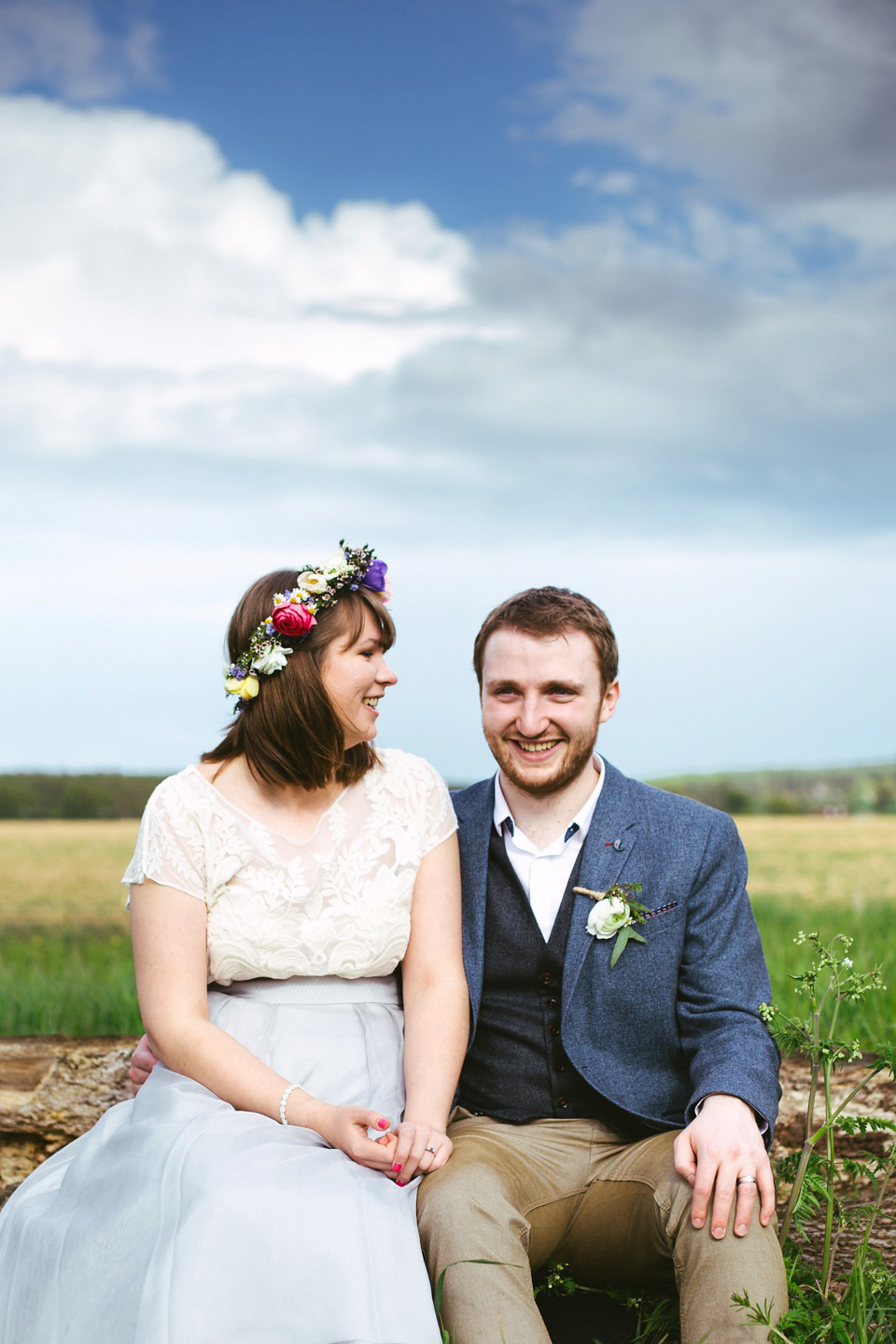 The bride wears a top and skirt for her charming orchard wedding. Photography by Cat Lane.