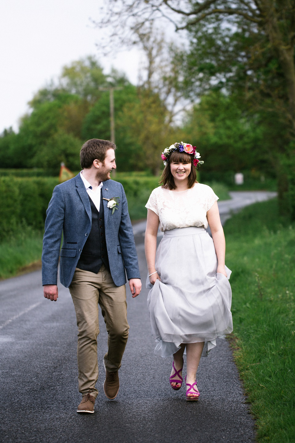 The bride wears a top and skirt for her charming orchard wedding. Photography by Cat Lane.