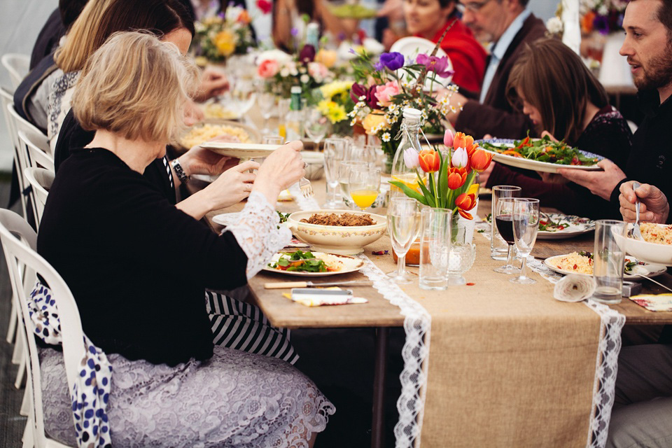 The bride wears a top and skirt for her charming orchard wedding. Photography by Cat Lane.