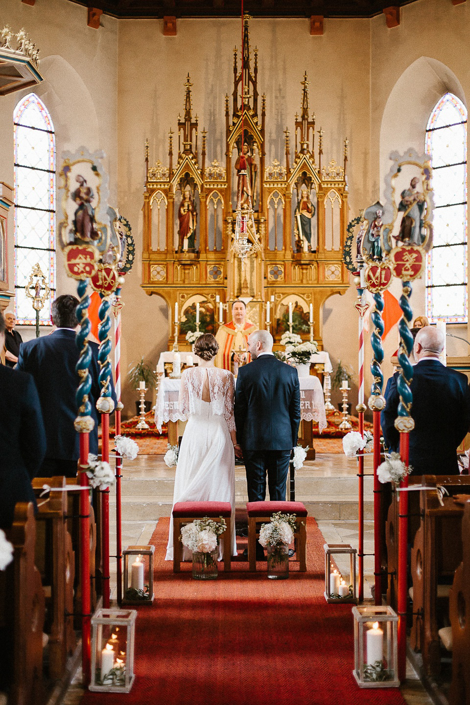 The bride wears Sarah Seven and a Ru de Seine lace blouse for her Boho Rustic Bavarian Farmhouse wedding. Photography by Kevin Klein.