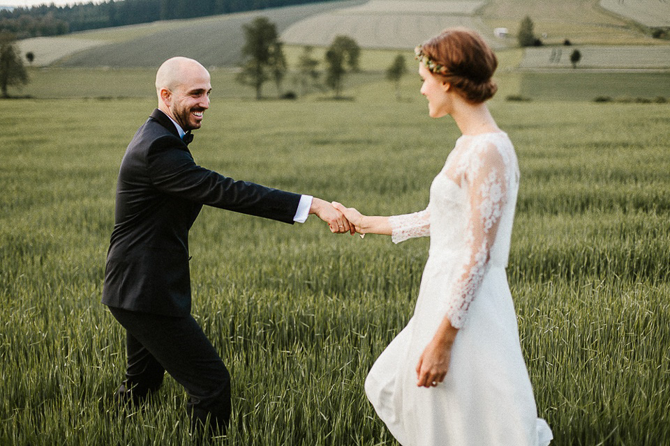 The bride wears Sarah Seven and a Ru de Seine lace blouse for her Boho Rustic Bavarian Farmhouse wedding. Photography by Kevin Klein.