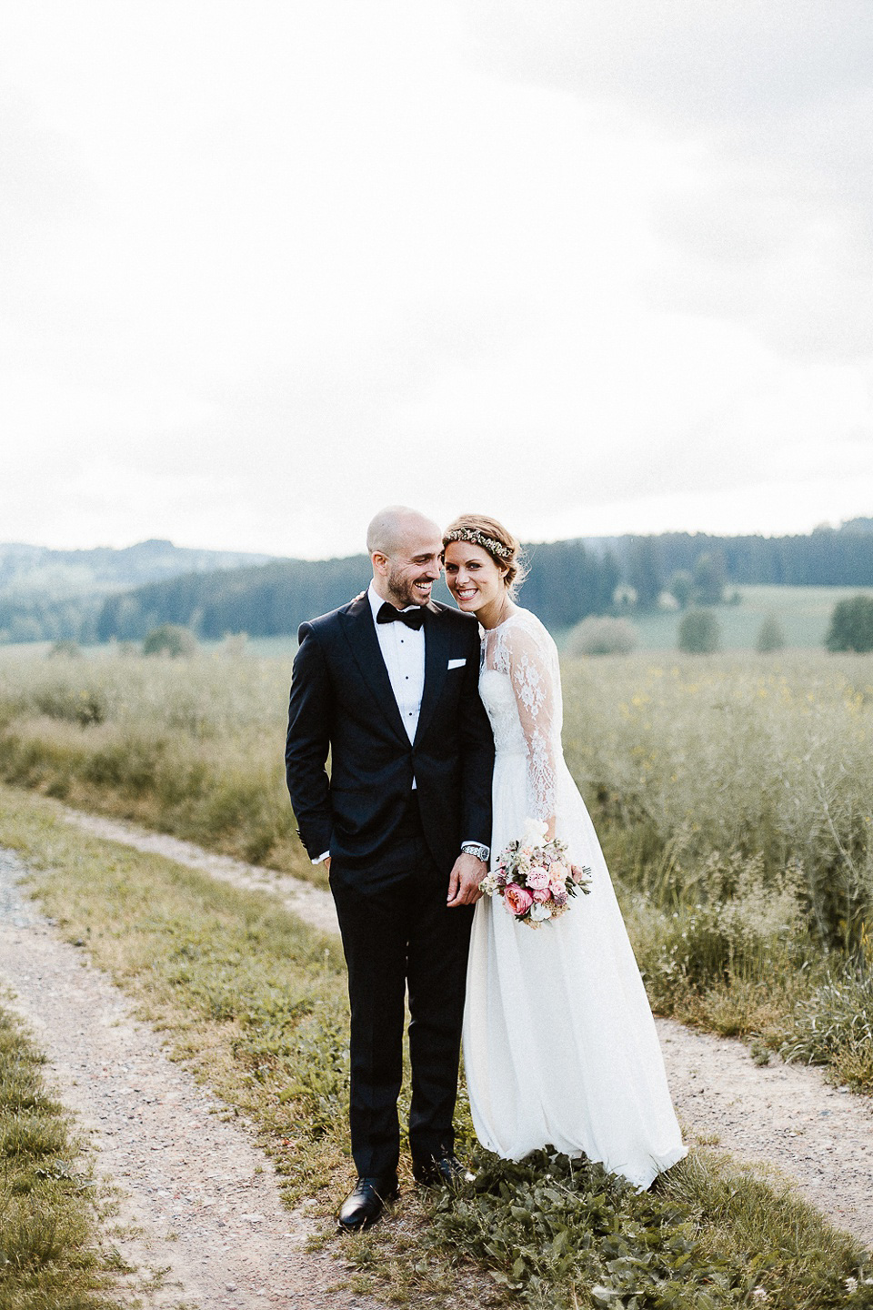 The bride wears Sarah Seven and a Ru de Seine lace blouse for her Boho Rustic Bavarian Farmhouse wedding. Photography by Kevin Klein.