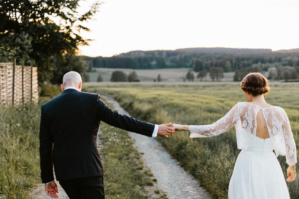 The bride wears Sarah Seven and a Ru de Seine lace blouse for her Boho Rustic Bavarian Farmhouse wedding. Photography by Kevin Klein.