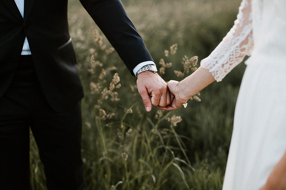 The bride wears Sarah Seven and a Ru de Seine lace blouse for her Boho Rustic Bavarian Farmhouse wedding. Photography by Kevin Klein.