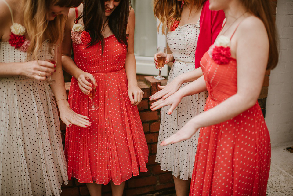 The bride wears a customised Alice & Olivia dress and 1950s wax flower headpiece for her Springtime village hall wedding. Photography by Ellie Gillard.