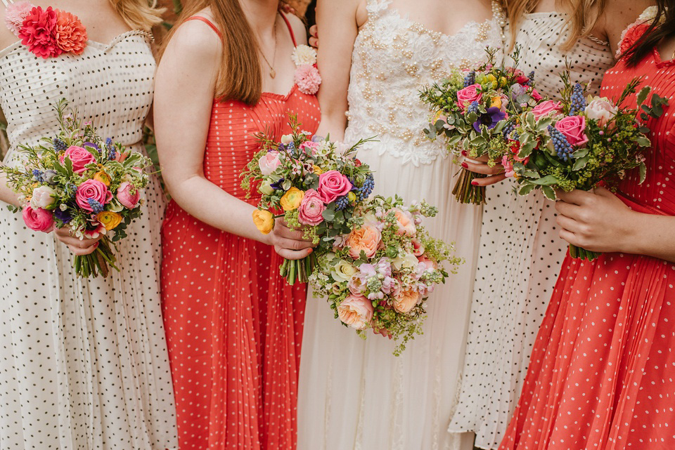 The bride wears a customised Alice & Olivia dress and 1950s wax flower headpiece for her Springtime village hall wedding. Photography by Ellie Gillard.