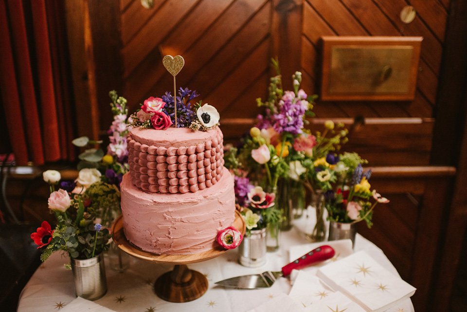 The bride wears a customised Alice & Olivia dress and 1950s wax flower headpiece for her Springtime village hall wedding. Photography by Ellie Gillard.