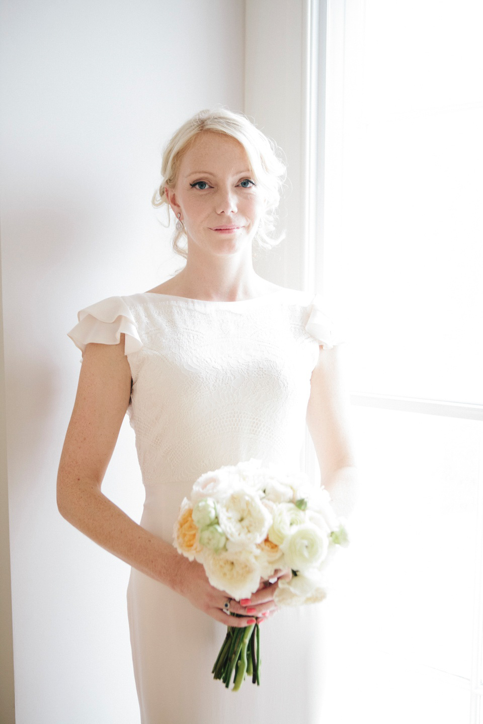 The bride wears a Belle & Bunty gown in blush for her child and family friendly wedding at Trinity Buoy Wharf in London. Photography by Kat Green.