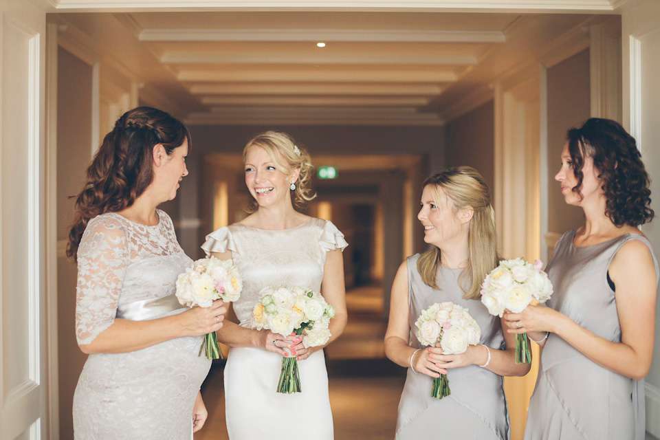 The bride wears a Belle & Bunty gown in blush for her child and family friendly wedding at Trinity Buoy Wharf in London. Photography by Kat Green.