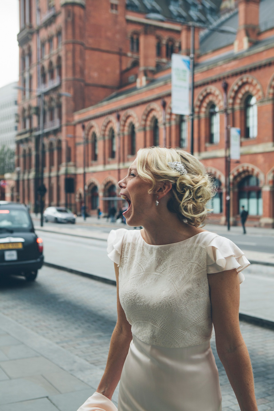 The bride wears a Belle & Bunty gown in blush for her child and family friendly wedding at Trinity Buoy Wharf in London. Photography by Kat Green.